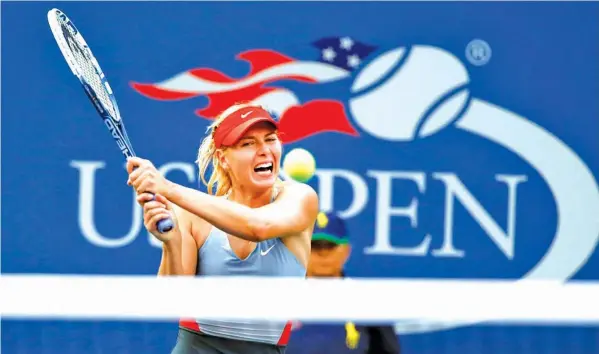  ?? ASSOCIATED PRESS ?? In this Aug. 27, 2014, file photo, Maria Sharapova, of Russia, returns a shot to Alexandra Dulgheru, of Romania, during the second round of the U.S. Open tennis tournament, in New York. Sharapova has been granted a wild-card invitation for the U.S....