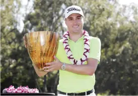  ?? — AP ?? KAPALUA: Justin Thomas holds the champions trophy after the final round of the Tournament of Champions golf event, Sunday, at Kapalua Plantation Course in Kapalua, Hawaii.