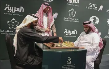  ??  ?? In this Monday photo released by Saudi Press Agency, two Saudi officials play chess during the opening of the first ever chess tournament in Riyadhi. Saudi Arabia is hosting a world chess tournament for the first time on Tuesday nearly two years after...