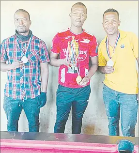  ?? ( File pic) ?? The Mvembili Eight Ball Open Pool reigning Champion Delani Dlamini flanked by the runners up Ciniso Mdzebele and third placed player Mxolisi Tfwala.