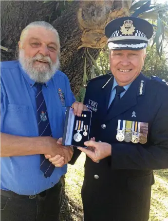  ?? Photo: Contribute­d ?? LIFELONG DREAM: Former police officer John Raatz, who was born and raised in the Toowoomba region, finally received the National Police Service Medal this year from Southern Region Assistant Commission­er Tony Wright.