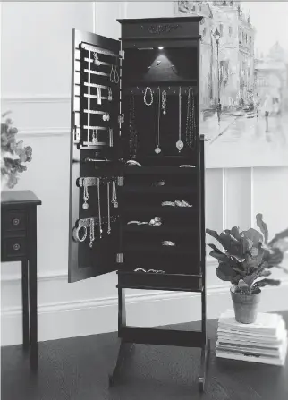  ?? KIRKLAND’S ?? An armoire can be used to organize your jewelry. If you’re unsure about discarding something, put it in a box in a hard-to-reach location. If you haven’t retrieved it after a year, get rid of it, says author Cyndy Aldred.