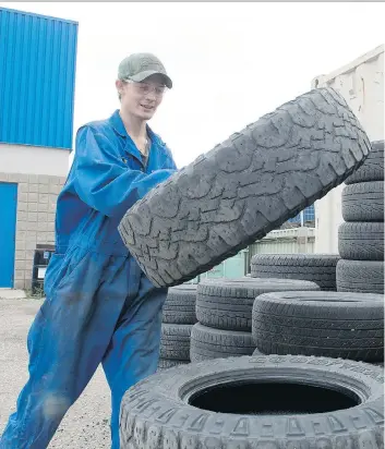  ?? MICHAEL BELL ?? Brodie Luther piles used tires behind Fountain Tire. Recycling of scrap tires in the province will now be the responsibi­lity of a new non-profit agency, Tires Stewardshi­p of Saskatchew­an.