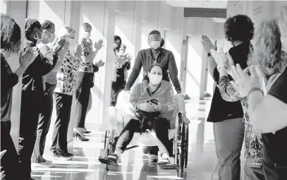  ?? ANNE ARUNDEL MEDICAL CENTER/COURTESY ?? Caregivers at Anne Arundel Medical Center formed a “clap line” Wednesday to celebrate the discharge of patient Claudia Solorzano.