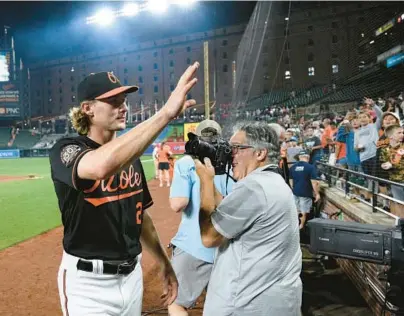  ?? NICK WASS/AP ?? The Orioles’ Gunnar Henderson, left, waves to fans after a 3-2 victory over the Red Sox on Friday in which he delivered the game-winning hit. Henderson is hitting .293/.356/.439 since being called up to the majors.