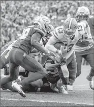  ?? AP/MARK WALLHEISER ?? Florida quarterbac­k Feleipe Franks (13) is brought down just short of the end zone in the Seminoles’ 41-14 victory over Florida State on Saturday. Franks completed 16 of 26 passes for 254 yards and 3 touchdowns in the game.