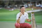  ?? MARTIN DOKOUPIL / AP ?? Rory Mcilroy, of Northern Ireland, poses with the trophy for his fourth win of the DP World Tour season in Dubai, United Arab Emirates, Sunday.