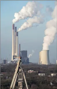  ?? (AP/Martin Meissner) ?? The Scholven coal-fired power station, owned by Uniper, steams Monday behind a closed coal mine in Gelsenkirc­hen. The power plant is being rebuilt from coal to a combined cycle gas turbine plant.