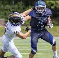  ??  ?? Cranbrook’s Ethan Peruski, right, uses stiff arm against Bishop Foley’s Drew Mleczko in the Cranes 43-41victory Saturday.