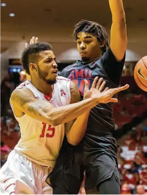  ?? Leslie Plaza Johnson ?? SMU forward Ben Moore, right, sticks close to UH’s Devin Davis, forcing a pass Saturday. The Mustangs rallied from a double-digit deficit for the second time in a week.