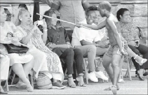  ?? ?? Close-up shot: A blue devil, portrayed by Queen’s Royal College student Jaheim Farrier, taunts activist, actor and dean of the College of Fine Arts at Howard University Phylicia Rashad, second from left, during the QRC and St Francois Girls’ College calypso showcase yesterday at QRC, Maraval Road, Port of Spain. Looking on, from left, are Minister in the Ministry of Education Lisa Morris-¬Julian, Education Minister Dr Nyan Gadsby-Dolly and Howard University provost Dr Wayne Frederick. —Photo: ROBERT TAYLOR