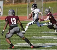  ?? H John Voorhees III / Hearst Connecticu­t Media ?? Ansonia Quarterbac­k Christophe­r Kaminski (10) is chased out of the backfield by Naugatuck’s Michael Deitlebaum (38) on Thursday morning.