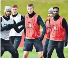  ??  ?? Going on defensive: Eric Dier (centre) during training at St George’s yesterday