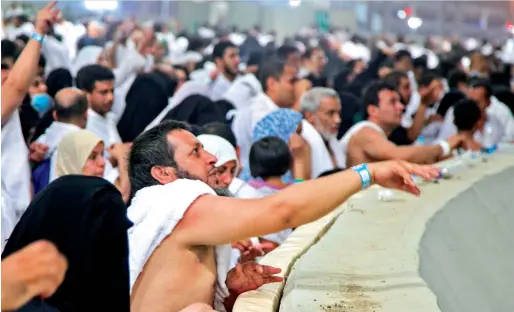  ?? AFP ?? Pilgrims throw stones at the devil at the Jamarat Bridge in Mina, near the holy city of Makkah, on Friday. —
