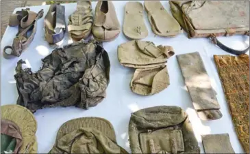  ?? SAHIBA CHAWDHARY ?? Shoes, clothes and bags used by S-21’s prisoners seen on display yesterday at Tuol Sleng Genocide Museum in Phnom Penh.