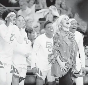  ?? RAY CARLIN/AP ?? Coach Kim Mulkey and players on the Baylor bench react to a blocked shot during the team’s 68-57 win over No. 1 Connecticu­t on Thursday.