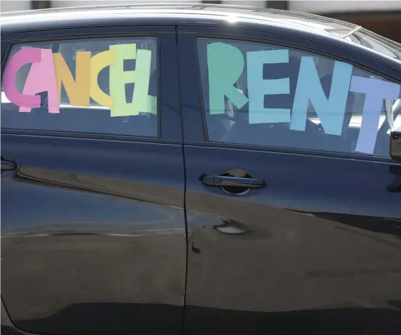  ?? PAuL CONNORS / BOStON HeRALd ?? ‘PRICES WILL FALL’: A sign reading ‘cancel rent’ is displayed on a car driven by a Party for Socialism and Liberation member last month during a national movement to call for a cancellati­on of rent and mortgage payments during the pandemic.