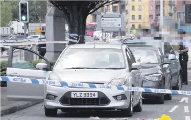  ??  ?? Police at the scene on the Albertbrid­ge Road yesterday afternoon after an elderly man was knocked down