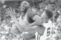  ?? JOHN LOCHER/AP ?? The Boston Celtics’ Tacko Fall drives into the Memphis Grizzlies’ Bruno Caboclo during the first half of an NBA Summer League game on July 11 in Las Vegas.