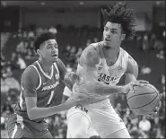  ?? AP/LAURA McKENZIE ?? Texas A&amp;M’s Brandon Mahan (right) tries to pass the ball around Arkansas’ Isaiah Joe (1) in the first half of the Razorbacks’ 73-71 victory over the Aggies on Saturday. Joe finished with 11 points in the victory.