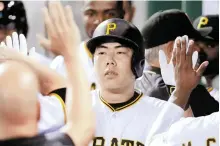  ?? AP-Yonhap ?? Pittsburgh Pirates’ Kang Jung-ho celebrates in the dugout with teammates after hitting a solo home run off St. Louis Cardinals starting pitcher Luke Weaver during the fourth inning of a baseball game in this Sept. 6, 2016, file photo.