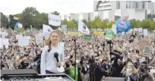  ?? — AFP ?? Swedish climate activist Greta Thunberg speaks to demonstrat­ors taking part in a Fridays for Future global climate strike in Berlin on Friday, two days ahead of the German federal election.