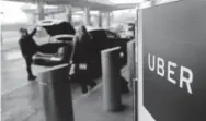  ?? Seth Wenig, Associated Press file ?? A sign marks a pickup point for the Uber car service at Laguardia Airport in New York. A report by an advocacy group says such ride-hailing services offer few options for people with disabiliti­es.