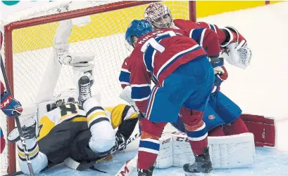  ?? FRANK GUNN THE CANADIAN PRESS ?? Penguins Sidney Crosby wound up in the net, thanks to Canadiens defenceman Brett Kulak, but Carey Price ensured no pucks did.