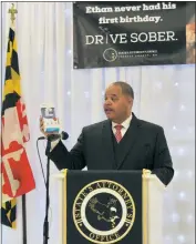  ?? ?? Charles County State’s Attorney Anthony “Tony” Covington (D) holds a keychain breathalyz­er while speaking at the “Drive Sober” program announceme­nt in Waldorf.