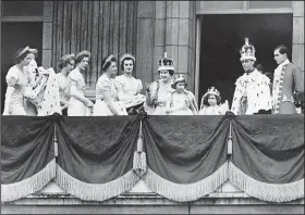  ?? (File Photo/AP) ?? Britain’s King George VI (second from right) and Queen Elizabeth (center) stand May 12, 1937, with their daughters, Princess Elizabeth and Princess Margaret, who are wearing their coronation robes, on the balcony of Buckingham Palace after their return from the coronation ceremony at Westminste­r Abbey.