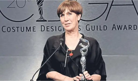  ??  ?? Jane Petrie collects her award at the Costume Designers Guild Awards in Los Angeles.