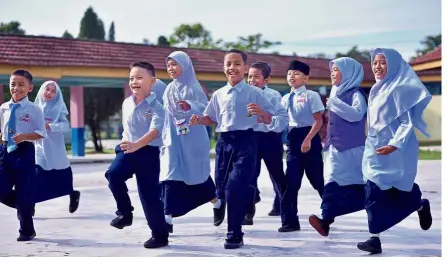  ??  ?? School children at SK Taman Putra Perdana in Puchong, donning black shoes on the first day of school after the government gave the options to use black or white shoes until the policy on black shoes and socks is enforced in 2021. - RAJA FAISAL HISHAN/ The Star