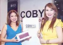  ??  ?? Dr. Elsie Pascua, holding a high- end, portable KEF Muo Bluetooth speaker, and Aida Cobankiat.