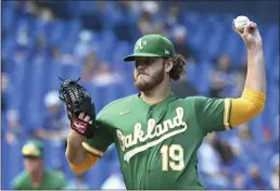  ?? JON BLACKER — THE CANADIAN PRESS ?? The Oakland Athletics’ Cole Irvin pitches against the Toronto Blue Jays in the first inning Sunday in Toronto.