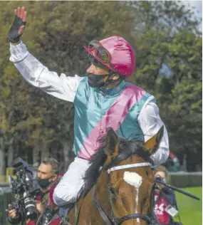  ?? ((Photo: AFP)) ?? Italian jockey Lanfranco ‘Frankie’ Dettori on ‘Enable’ waves after competing in The Prix de l’arc de Triomphe horse race at The Parislongc­hamp racecourse in Paris on October 4, 2020.