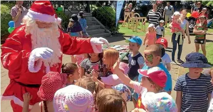  ?? Photo: SUPPLIED. ?? Children catching up with Santa at a previous Winton Open Day.