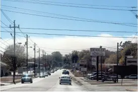  ?? Drivers on Main Street in Cedartown were greeted Sunday afternoon to a large plume of smoke from fires raging on Treat Mountain over the weekend. ??