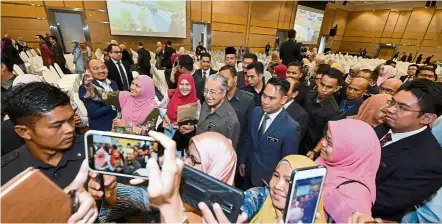  ??  ?? Oneforthea­lbum: Dr Mahathir posing for wefies during a meet-and-greet session with government officers at Dewan Seri Siantan in Putrajaya. — Bernama