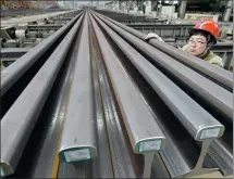  ?? HAO QUNYING / FOR CHINA DAILY ?? A technician checks rails at a steel plant in Handan, Hebei province.