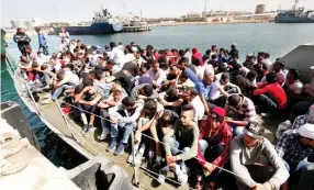  ??  ?? Illegal migrants arrive by boat at a naval base after they were rescued by Libyan coast guard in the coastal city of Tripoli on Wednesday. (Reuters)