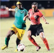  ?? FILE ?? Jamaica’s Khadija Shaw (left) makes a tackle on Trinidad and Tobago’s Mackenzie Marsh in the Caribbean Football Union Women’s under 20 final at the Anthony Spauldings Sports Complex in 2013. Shaw scored on Sunday in the Girlz 2-2 draw with Haiti in the...