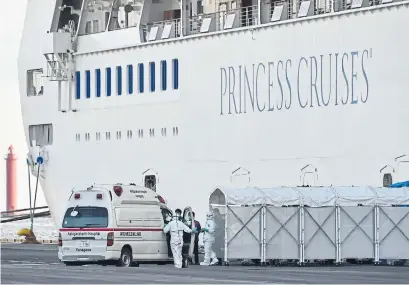  ?? KAZUHIRO NOGI AGENCE FRANCE-PRESSE ?? Personnel tasked with providing care for suspected coronaviru­s patients on board the Diamond Princess prepare for a transfer.