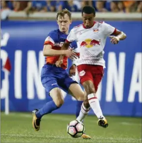  ?? JOHN MINCHILLO — THE ASSOCIATED PRESS ?? FC Cincinnati midfielder Jimmy McLaughlin, left, vies for a ball with New York Red Bulls midfielder Tyler Adams in the second half of a U.S. Open Cup soccer semifinal.