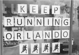  ?? GABRIELLE RUSSON/ORLANDO SENTINEL ?? The Track Shack displays an inspiratio­nal message for runners on Mills Avenue.