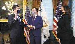  ?? Andrew Harnik / Associated Press ?? Pete Buttigieg is sworn in by Vice President Kamala Harris.