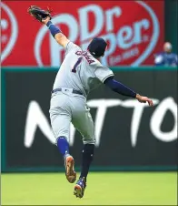  ?? RON JENKINS / GETTY IMAGES / AFP ?? With his back to the infield, Carlos Correa of the Houston Astros snags a fly ball in the eighth inning of Sunday’s 7-2 victory over the Texas Rangers at Globe Life Park in Arlington, Texas.