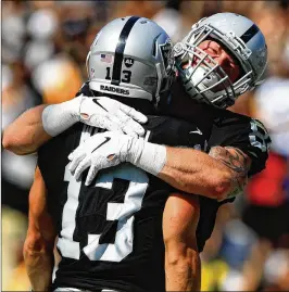  ?? SEAN M. HAFFEY / GETTY IMAGES ?? Paul Butler congratula­tes Griff Whalen (13) of Oakland on his touchdown in the preseason game against the Rams on Saturday at Memorial Coliseum. It was the Raiders’ first game in their old stadium in nearly 24 years.
