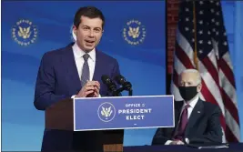  ?? KEVIN LAMARQUE — POOL ?? Former South Bend, Ind., Mayor Pete Buttigieg, President- elect Joe Biden’s nominee to be transporta­tion secretary, reacts to his nomination as Biden looks on during a news conference at The Queen theater in Wilmington, Del., on Wednesday.