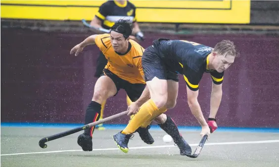  ??  ?? Easts’ Tyler Arundel (left) and Labrador’s Luca Brown fight it out in the Brisbane Hockey Associatio­n Division 1 grand final clash. Picture: Renae Droop