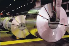  ?? PETER POWER/THE CANADIAN PRESS/AP ?? Shadows of workers are cast on rolls of coated steal at Stelco in Hamilton, Ontario. Canada has imposed tariffs on $12.6 billion in U.S. goods as retaliatio­n for the Trump administra­tion’s new levies.